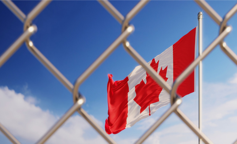 Fence In Front Of Canadian Flag