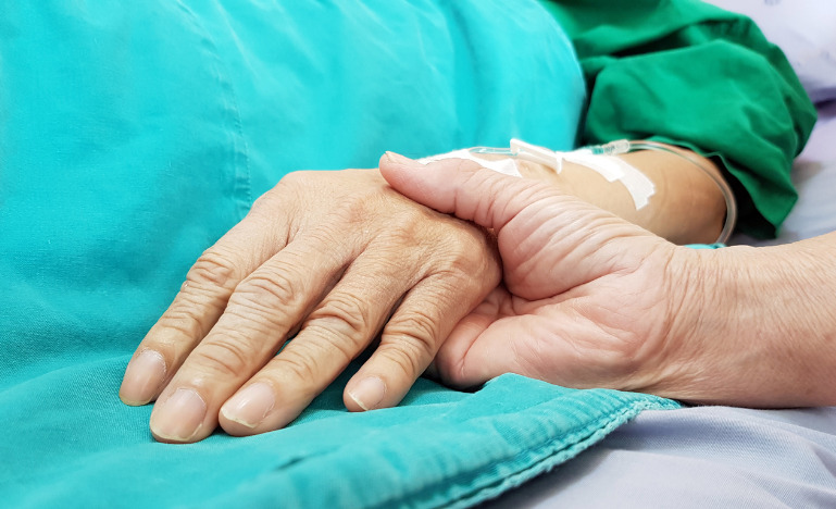 Holding a patient's hand