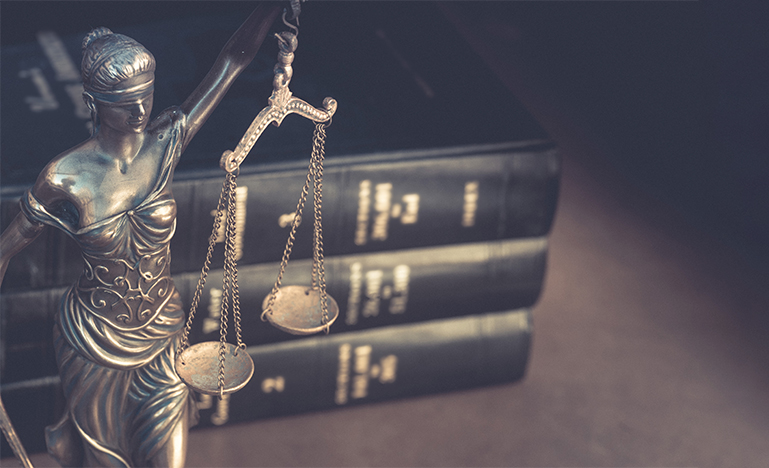 Lady justice with law books on faded background