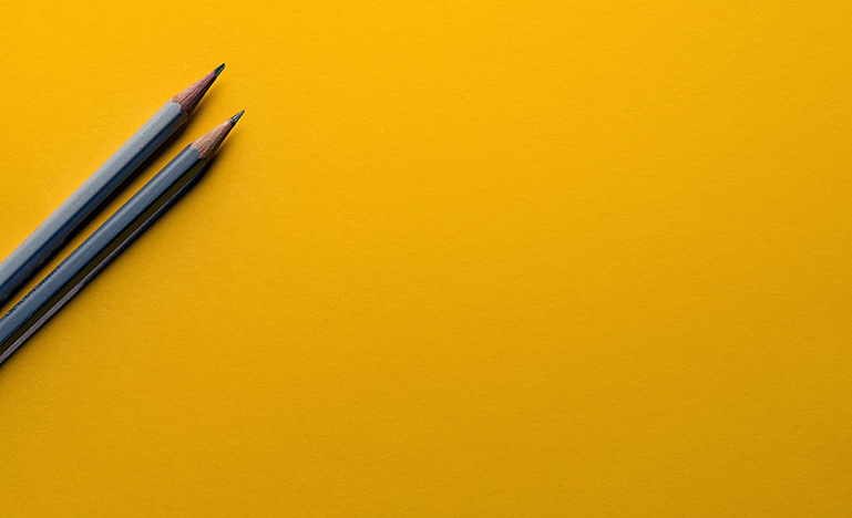 pencils on yellow background
