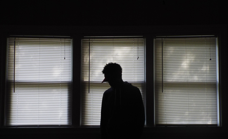 silhouette of man by windows