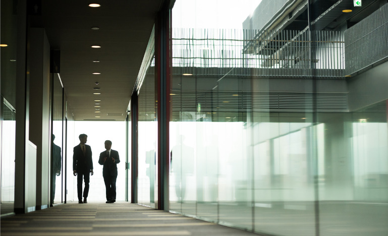 Conversation between silhouetted men