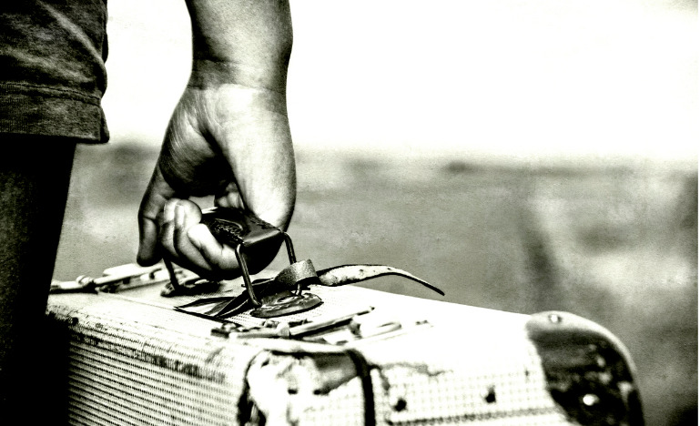 Refugee girl with suitcase