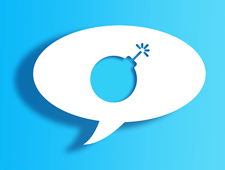 White Chat Bubble With Cut Out bomb Shape Over Blue Background 