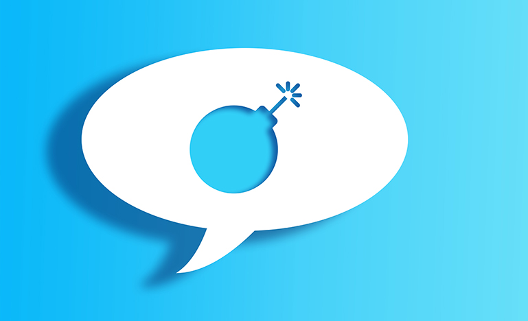 White Chat Bubble With Cut Out bomb Shape Over Blue Background 