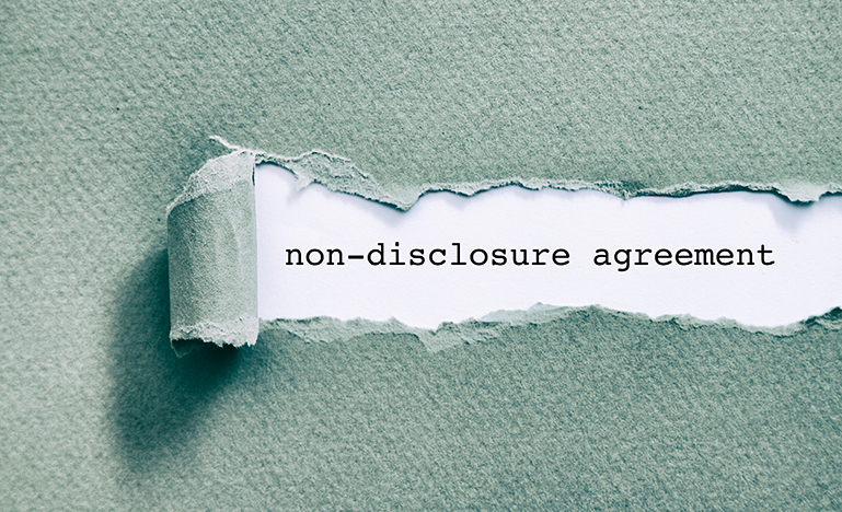 Image of envelope peeling back the words "non-disclosure agreement’