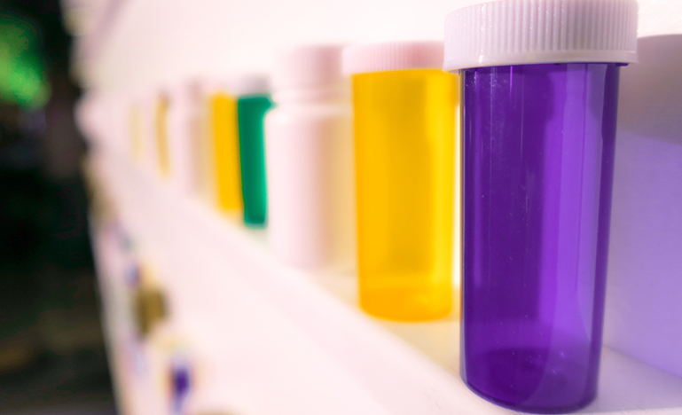 Different coloured pill bottles.
