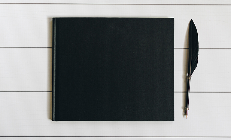 black notebook and pen