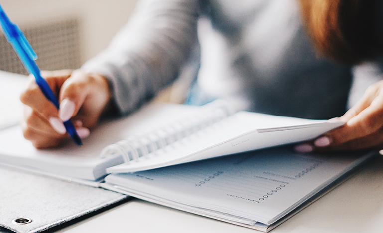 Woman writing in a notebook