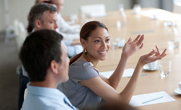Woman of colour speaking in a boardroom 