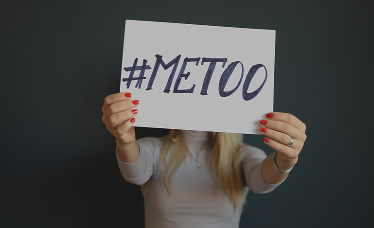 Woman holding sign that reads '#METOO'