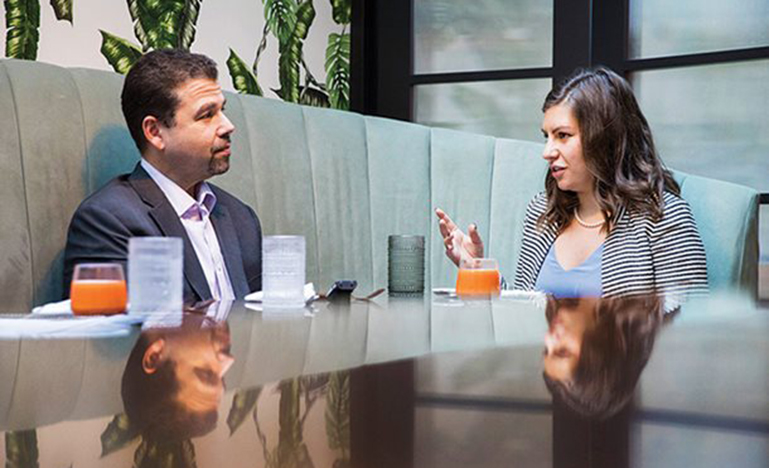 Doron Gold and Madeleine Tyber at a table