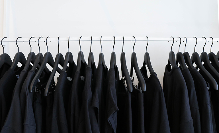 Black outfits hanging in closet