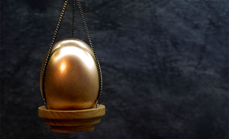Gold egg on a scale