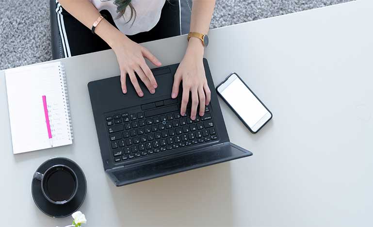 High angle view of Woman using laptop at table