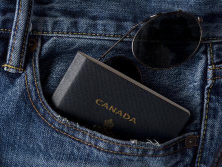 Canadian passport and sunglasses in jean pocket