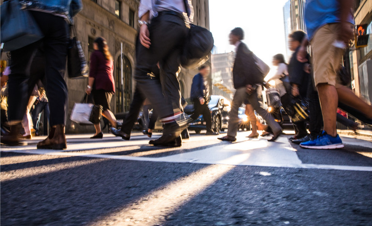 People at crosswalk downtown in a city